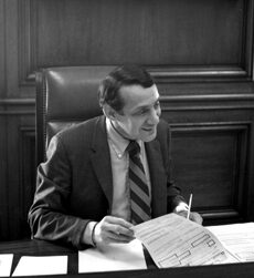 Harvey Milk at Mayor Moscone's desk, 1978